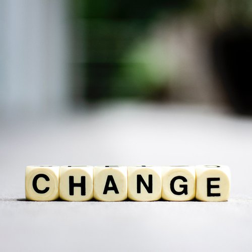 small, square blocks are spelling out the word "change"
